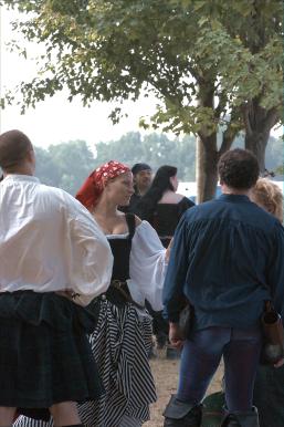 The crowd gathers at the gate, pirate women too.