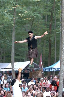 Yes, that is a man in a kilt walking a tight rope over a crowd.