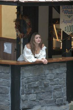 Drink booth girl without any customers.